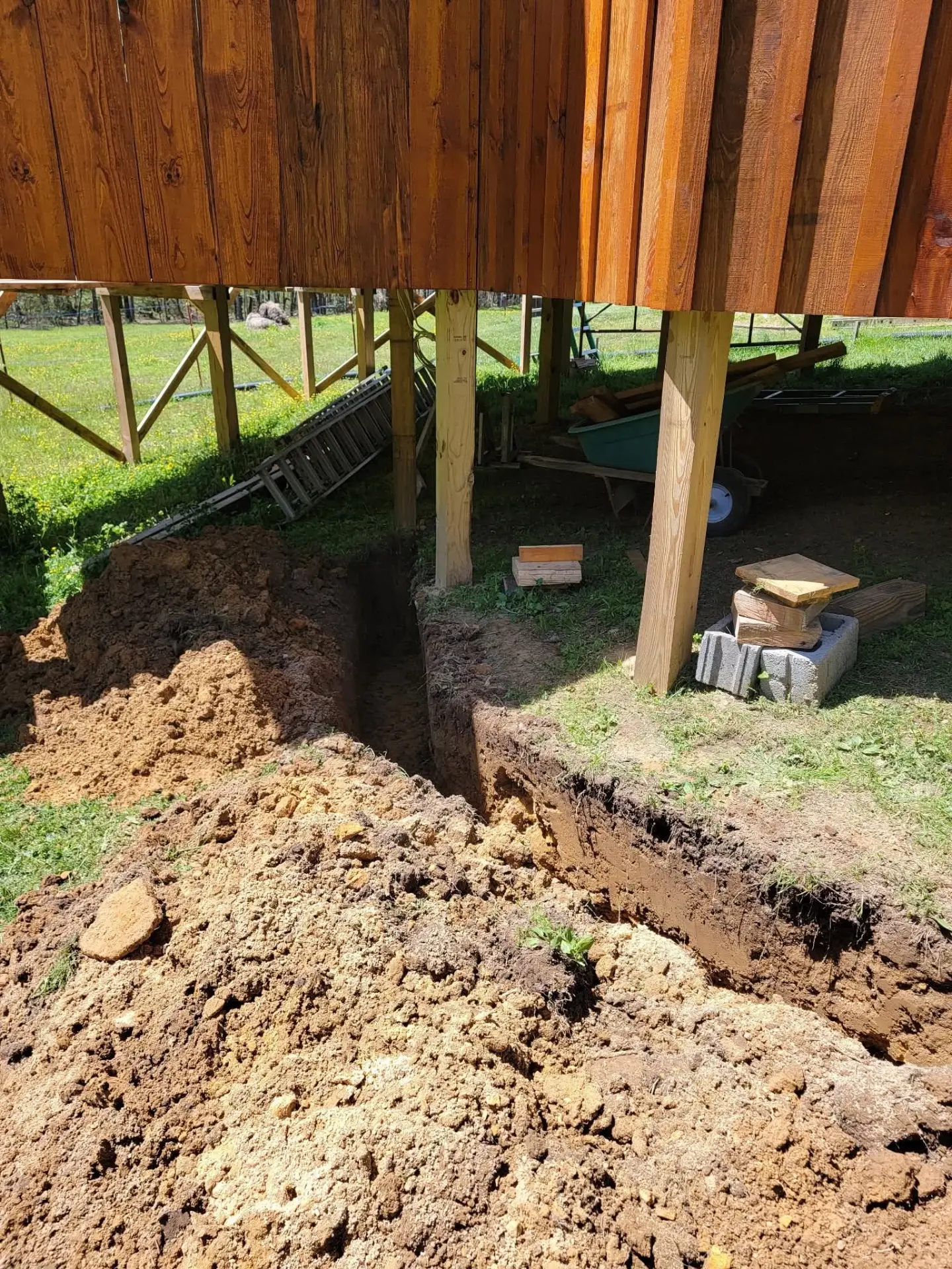 Deep trench dug under a raised cabin