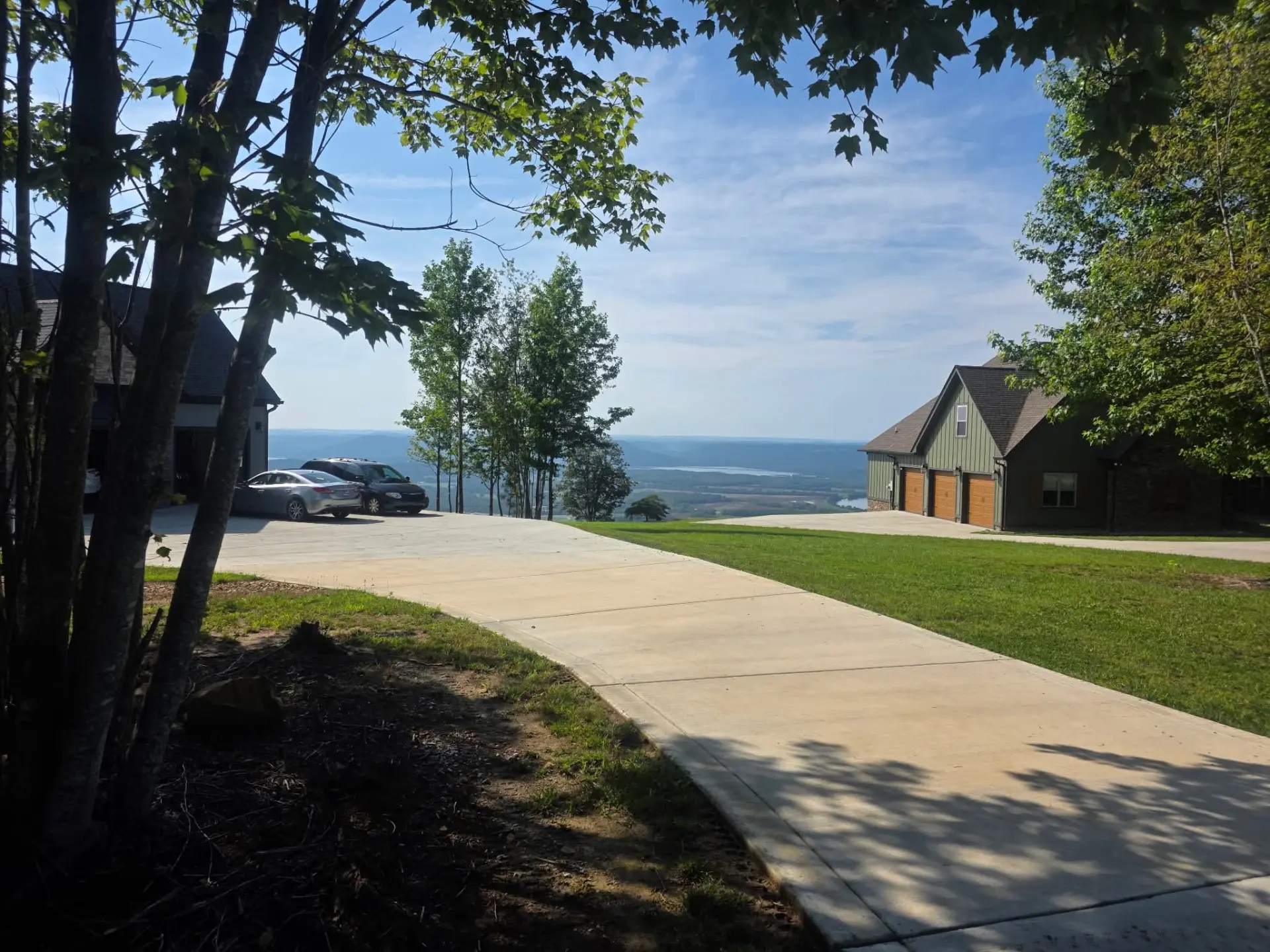 Long concrete driveway on a mountaintop property with a valley view
