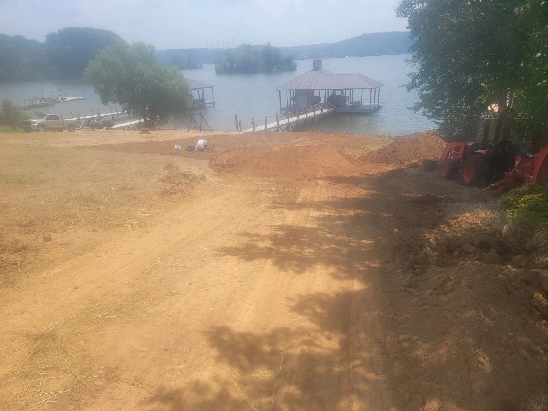 Graded lakefront lot sloping down to a boat dock