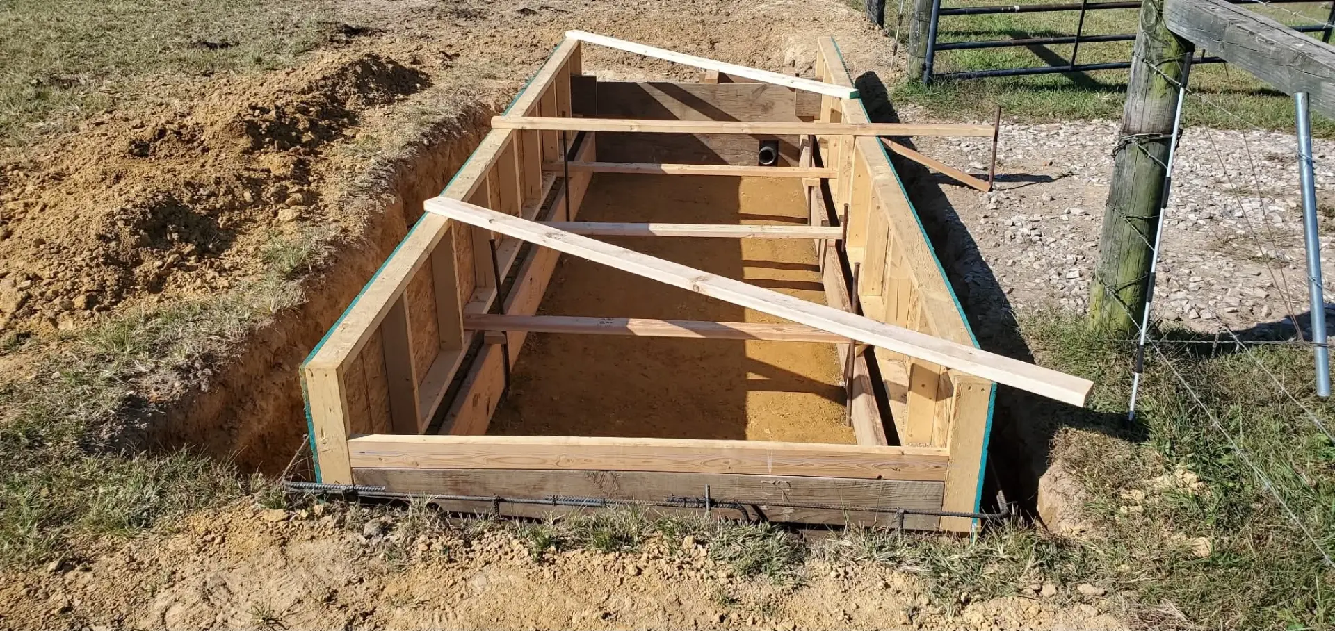 Wooden concrete forms with rebar set in an excavated footing